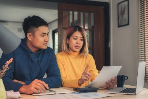 Couple discussing taxes in their home and online